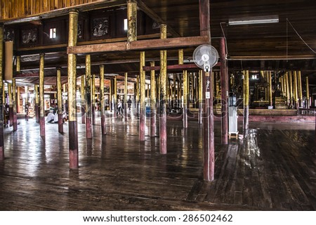 NIAUNGSHWE, MYANMAR - FEBRUARY 2, 2015: Inside Nga Phe Kyaung or jumping cats moastery, at the Inle lake, Myanmar. The monastery is constructed completely from teak wood.