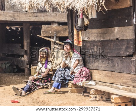 LOIKAW, MYANMAE - FEBRUARY 7, 2015: women of the Padaung tribe are sitting on the terrace of their house in a Padaung village near Loikaw, Myanmar