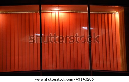 Night window of cafe with red jalousie