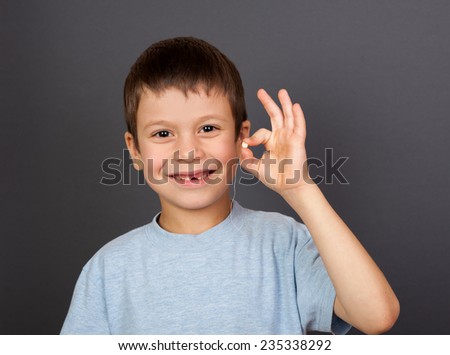 boy with lost tooth on a thread
