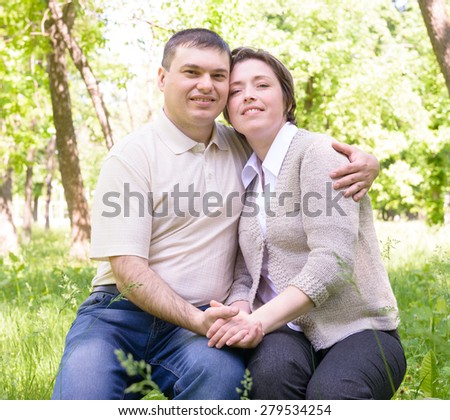 Unhappy couple in green summer park