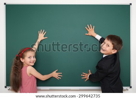 boy and girl write on school board