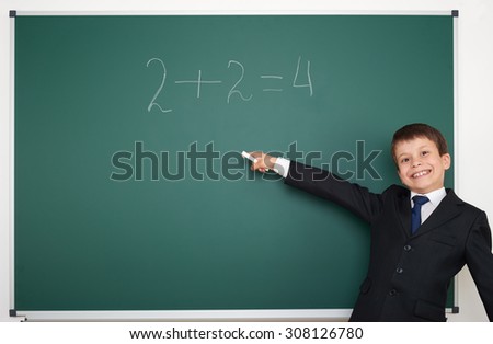 School boy solve math on the school board