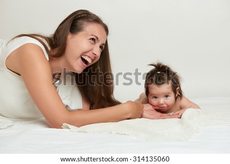 baby biting finger mother white background