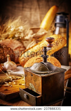 Country still life with bread, cheese, mushrooms and wine in an antique jar