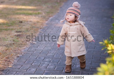 Cute little girl walking in the park