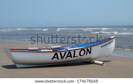 AVALON, NEW JERSEY - June 26, 2013.  A beach patrol boat rests on the shore in Avalon, New Jersey welcoming visitors back after Hurricane Sandy devastated parts of the area several months earlier.