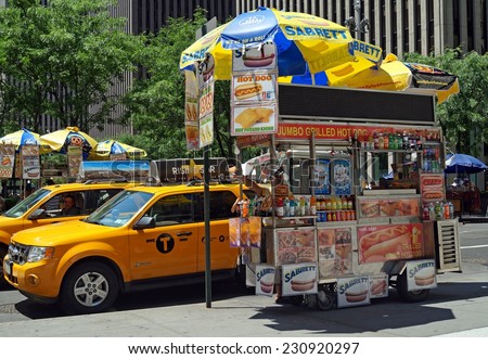 NEW YORK, NEW YORK - June 29, 2014:  Hot Dog Cart.  A hot dog cart selling hot dogs, soft pretzels and drinks on a street corner in New York City.