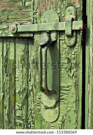 This old peeling green paint door with vintage latch hardware is ajar just inviting us to take a look inside.