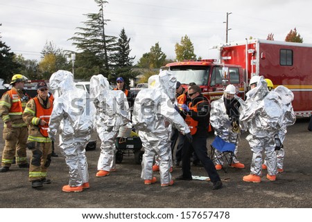 EUGENE, OREGON, USA  November 3, 2011: Eugene fire departments & emergency teams conduct disaster drills. This HAZMAT team is suiting up with PPE to protect them from hazardous materials.