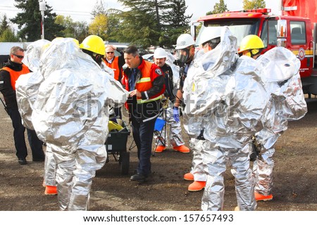 EUGENE, OREGON, USA November 3, 2011: Eugene fire departments & emergency teams conduct disaster drills. This HAZMAT team is suiting up with PPE to protect them from hazardous materials.