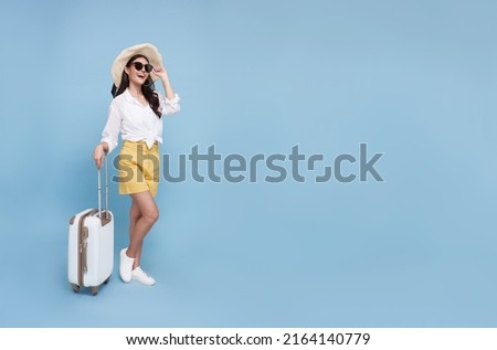 Similar – Image, Stock Photo Young casual female traveler at airport, holding smart phone device, looking through the airport gate windows at planes on airport runway.