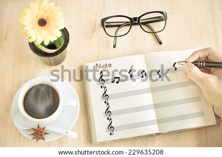 Composer with Music notes on notebook