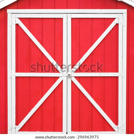 Classic red barn style door with white trim.