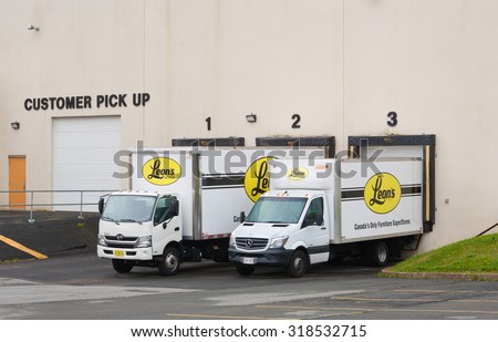 TRURO, CANADA - SEPTEMBER 20, 2015:  Leon\'s delivery trucks parked at loading bay. Leon\'s is a Canadian furniture store which  has outlets in all provinces, except British Columbia.