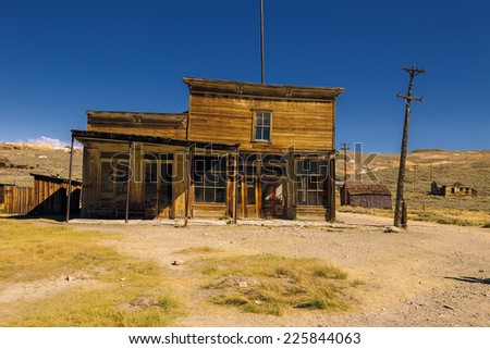 Crooked abandoned building of old western saloon and shop. Ruined business in Bodie Ghost Town