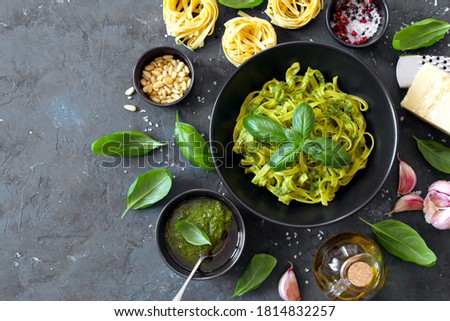 Similar – Image, Stock Photo Green tagliatelle pasta with ham, parmesan cheese, arugula and tomatoes on black plate