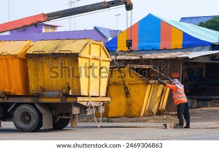 Image, Stock Photo moving yellow dumpster in front of a red brick wall