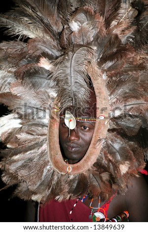 Warrior from a Masai tribe in the Masai Mara reserve in Kenya with a feathered headdress