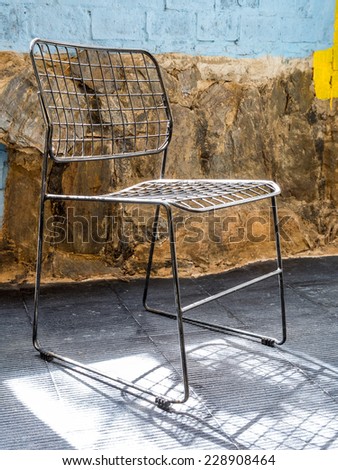 Interior design of  chair with rustic stone and brick-wall  background