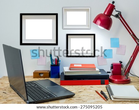Modern creative workspace with laptop computer on compressed plywood chipboard table top