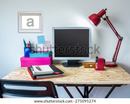 Modern creative workspace with computer on compressed plywood chipboard table top
