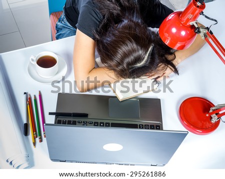 Top view of businesswoman get exhausted and sleeping with laptop computer on table