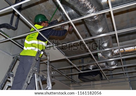 worker checking building ventilation