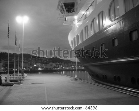 Hurtigruta cruise ship docked in black and white.