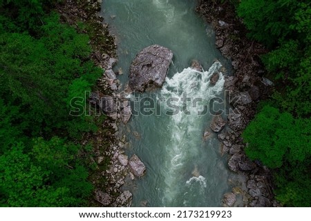 Drone aerial view of wild river Enns in cloudy weather in Gesause National Park near town of Admont in centre Austria. Visible green river banks, rapid water and some stones. Photo stock © 