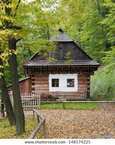 Wooden cottage house in autumn forest countryside, Roznov pod Radhostem, Czech Republic.