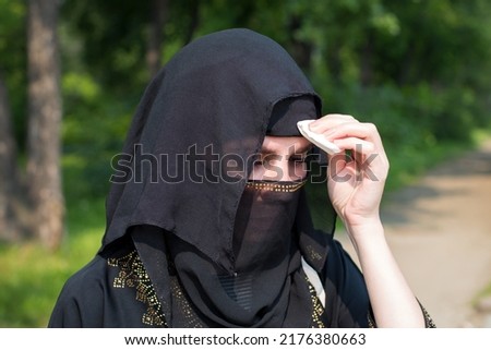 Image, Stock Photo Tired Arab woman wiping face with towel after training