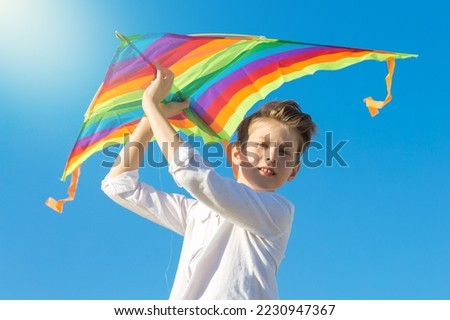 Similar – Image, Stock Photo Boy with striped kite on the beach in ICM technique.