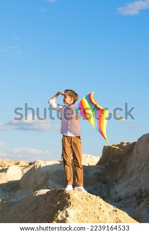 Similar – Image, Stock Photo Boy with striped kite on the beach in ICM technique.