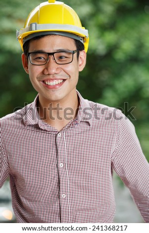 Asian male engineer with a yellow hard hat