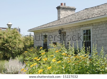 flower bed in front of an stone cottage