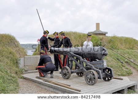 HALIFAX, NOVA SCOTIA - JULY 26: re-enactors perform an Artillery drill, loading a cannon at the Canada Citadel National Historic Site on July 26 2011 in Halifax Nova Scotia, Canada