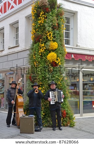 LAHR BADEN, GERMANY - OCTOBER 22: Unidentified three-man band street musician entertain visitors at the Chrysanthema Flower Festival in Lahr Baden, Germany on October 22, 2011