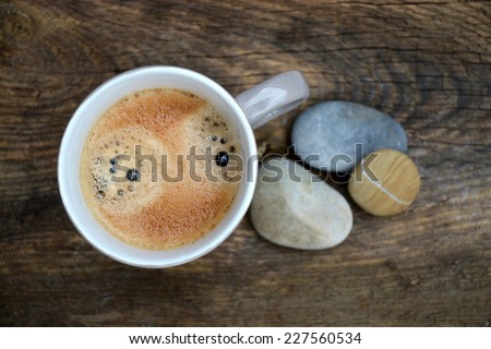 coffee on a old wood background with zen stones, coffee break