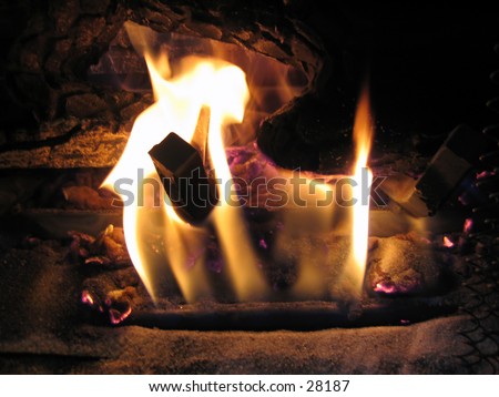 A warm fire in a home fireplace (natural gas fireplace).
