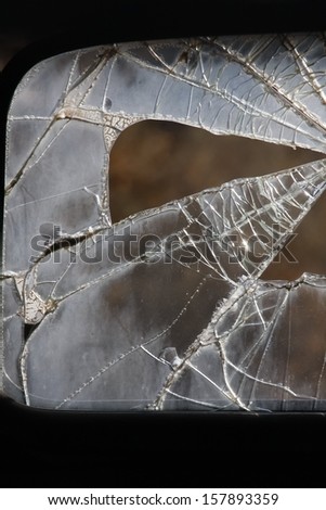 Broken glass in an old car window.