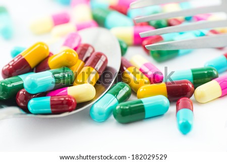 Colorful capsules on white