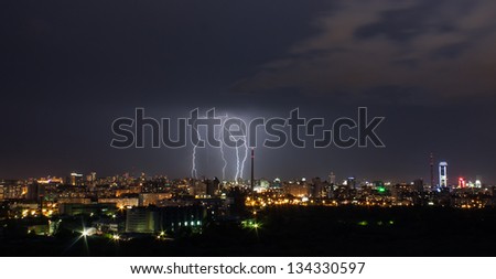 Thunderstorm over city in night