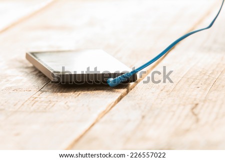 Cellphone with headphone cord attached.
