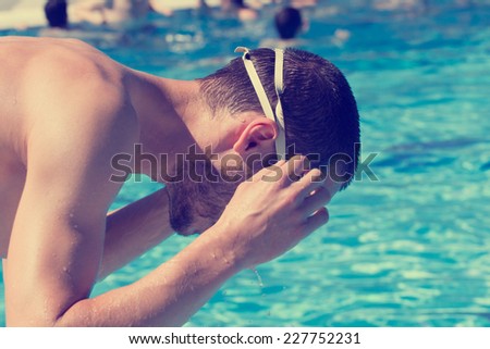 Swimmer preparing before entering the pool.