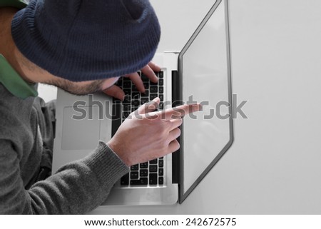 Hacker threatening to a victim over a laptop screen.
