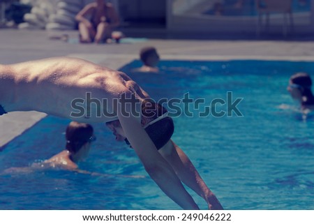 Swimmer jumping into the pool.