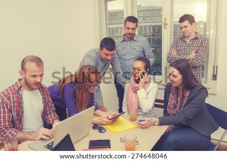 Young group of people discussing business plans.