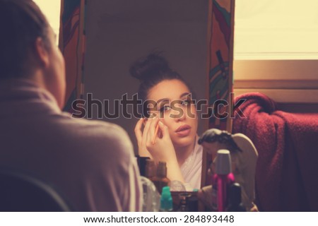 Girl doing some makeup before going out.