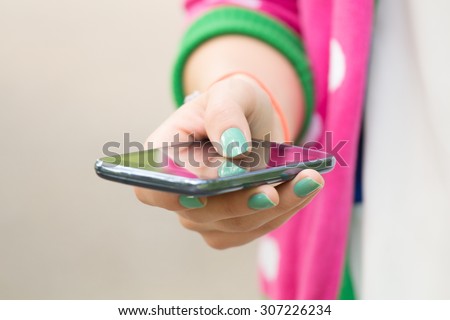 Texting on a smartphone. Shallow depth of field.